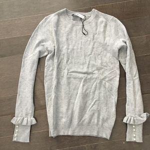Grey crew neck sweater with pearl buttons